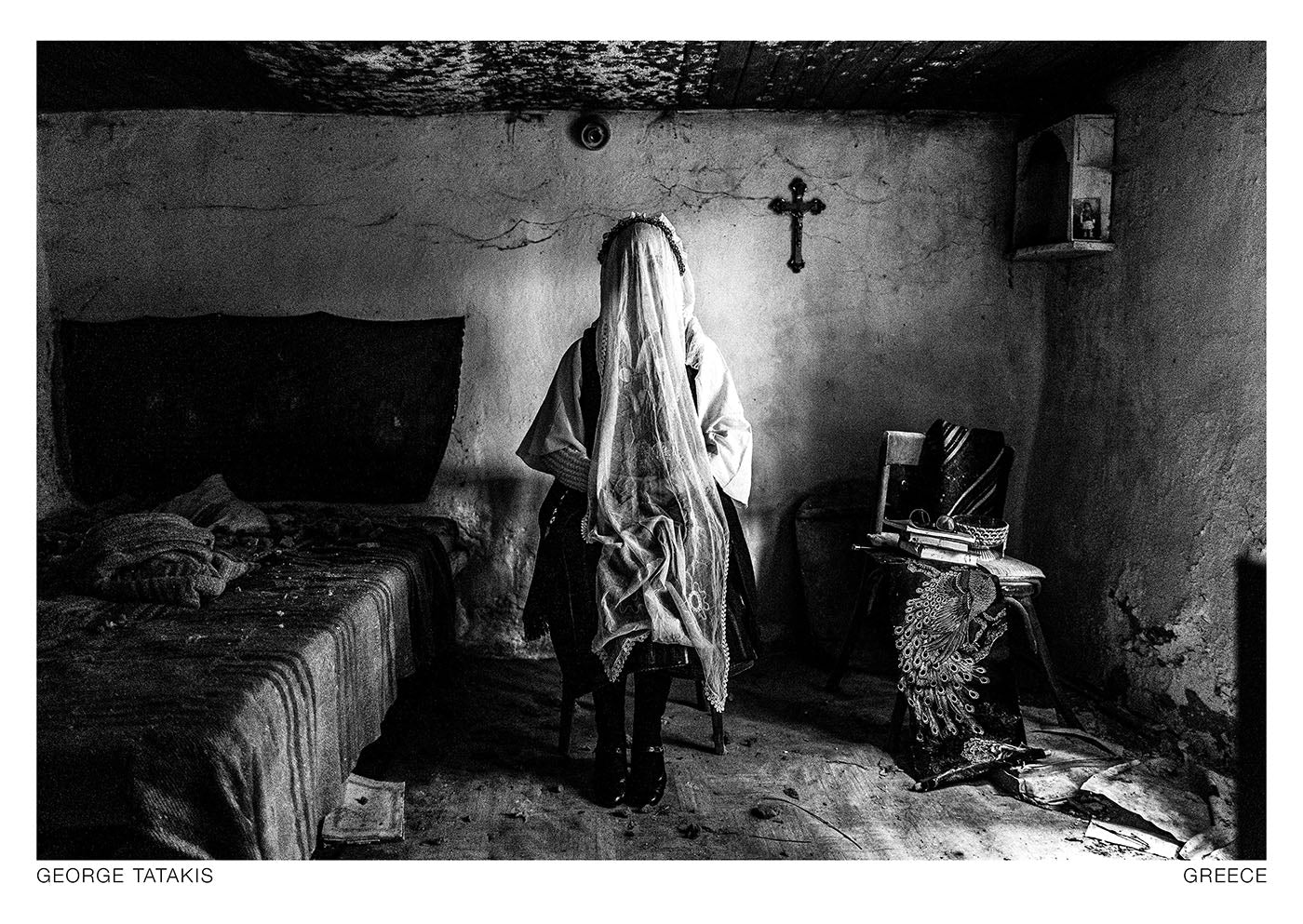 A veiled bridal portrait inside an abandoned traditional house in Ermakia, Macedonia, Greece. Black and white photography postcard by George Tatakis, project Caryatis.