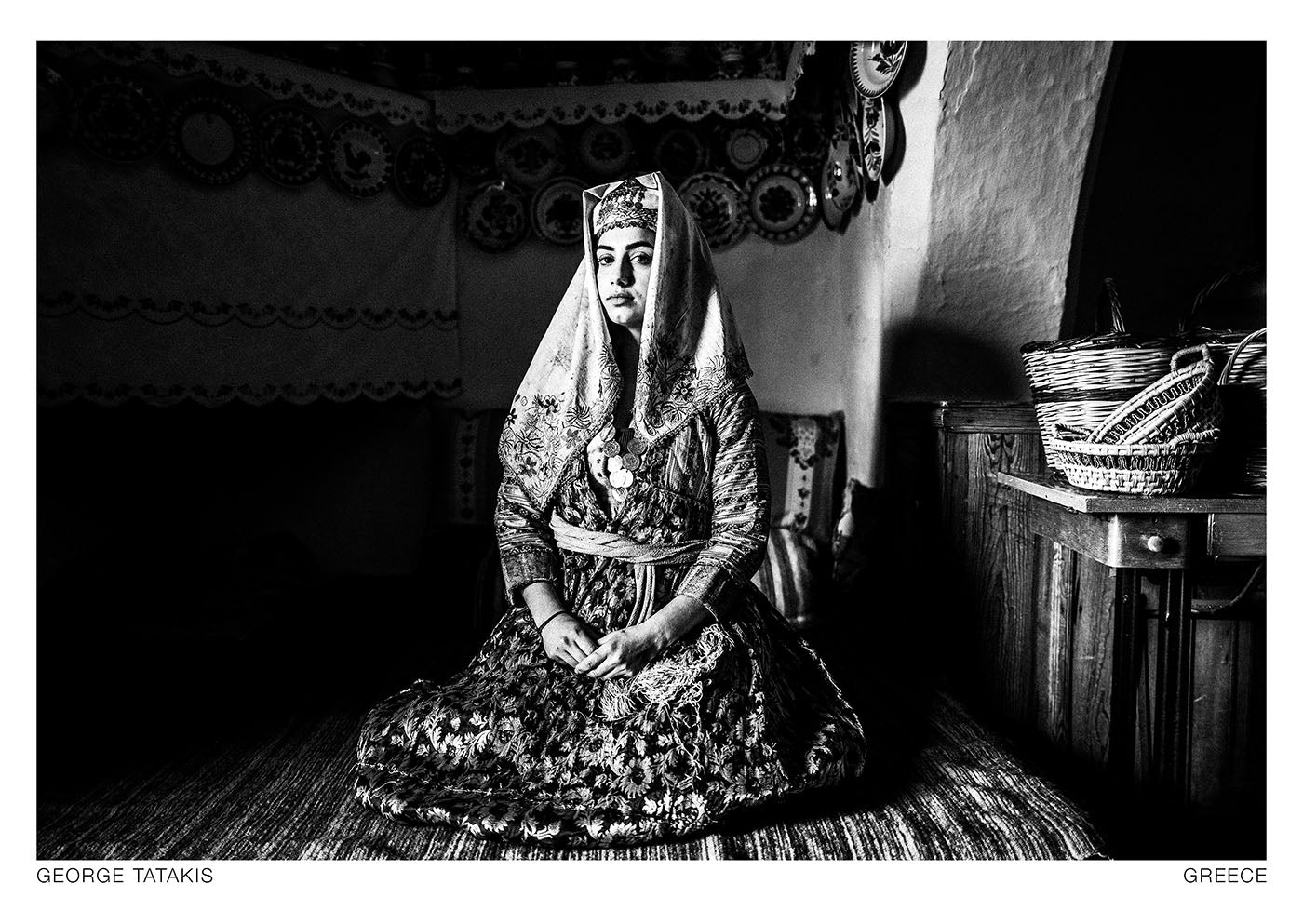 This photograph was made at the local folklore Museum of Archangelos village, Rhodes, Greece. The costume is an original taken from the Museum. Black and white photography postcard by George Tatakis, project Caryatis.
