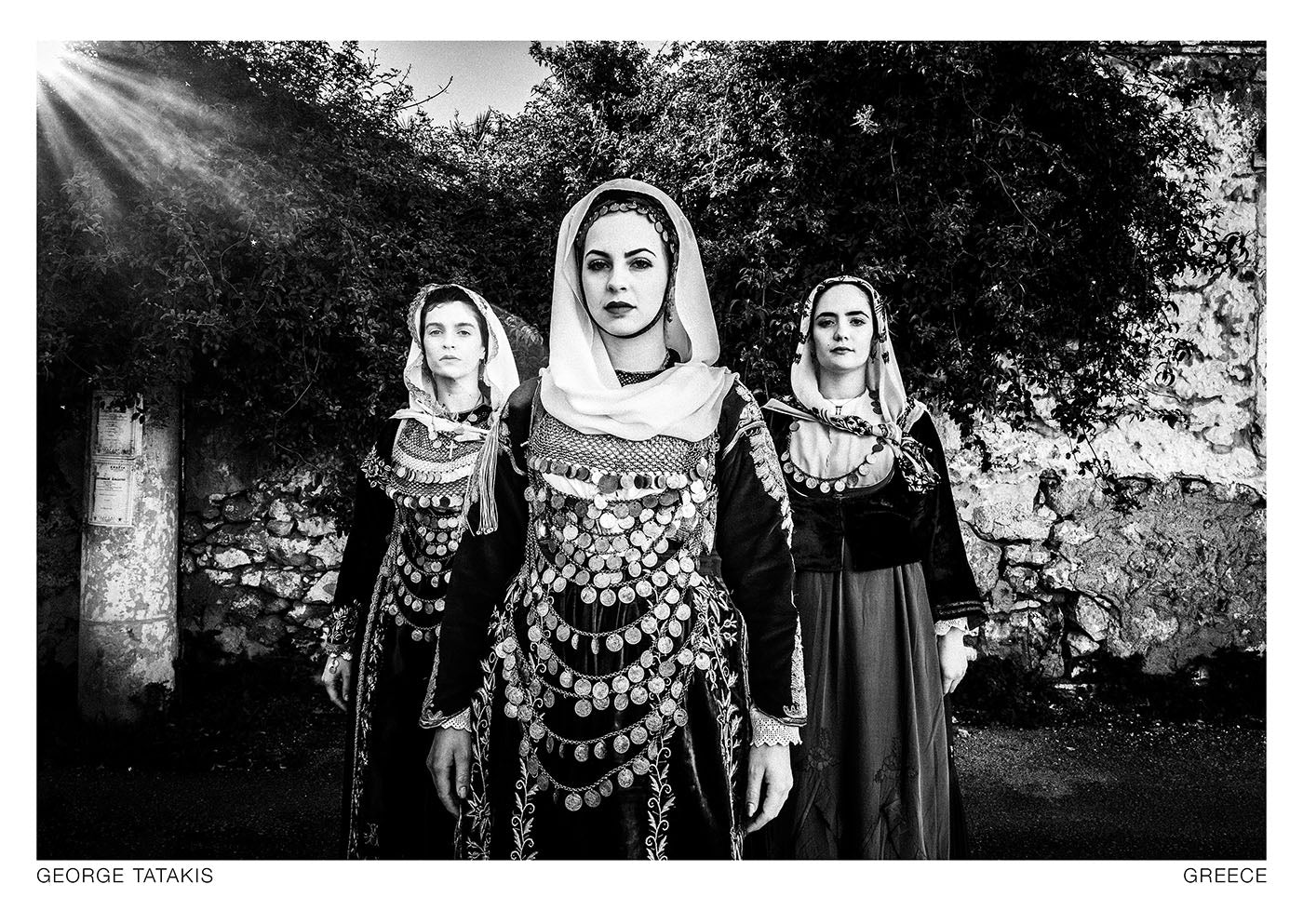 The three women in the photograph wear the bridal, engagement and daily costumes of the island of Salamina. Black and white photography postcard by George Tatakis, project Caryatis.
